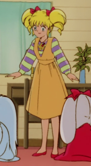 Eriko's baggy, lavender and pale mint green-striped long-sleeved shirt with an orange overall-dress. Often worn with lavender or orange bedroom slippers as she mostly wears it at home, although she also wears it with red flat shoes outside.