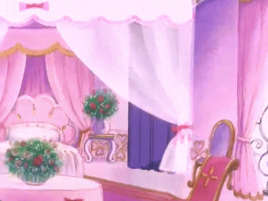 A luxurious pastel pink room with curtains drawn around either side, wall-length windows, a four poster bed with pink curtains and gold-coloured tassels, a large frilly pink pillow, a scalloped headboard, wooden clawfoot chairs with purple cloth backs, white bedside clawfoot tables, one with a vase and one with gold-coloured candelabra. A larger white, sheer curtain separates the sleeping area from a small, round white dining table with two wooden, red-cloth backed chairs, another flower vase on the white tablecloth, and there's another table in the corner with a flower vase. An oval wall mirror with a gold border hangs on the wall too.