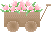 A wooden wheelbarrow of pink flowers.