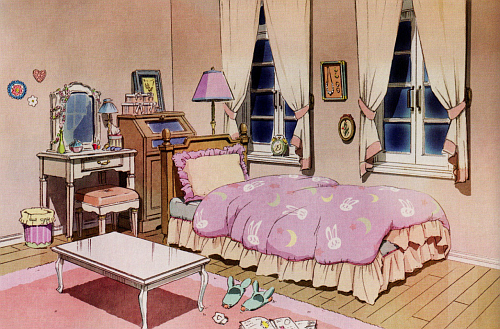 Concept art for Tsukino Usagi's bedroom. This shot focuses on Usagi's bed with a light pink blanket decorated with bunny faces, pink stars, and yellow crescent moons (similar to her 90's blanket, but without the bunnies jumping over the moon) and yellow frills around the edges, and a frilly pillow with the colours reversed from those of the blanket (light pink frills, pale yellow center.) She has two tall and narrow windows with white wooden panelling and white curtains drawn back with light pink sashes. An alarm clock sits in the windowsill closest to the head of the bed. A standing lamp with a pink lampshade is behind the bed. The bed has a brown wooden frame. There's a brown wooden door chest behind the bed, some pink boxes with white ribbons stacked on top of it, a framed picture, and next to that, a white vanity desk and chair. The chair has a plush pink seat, but is otherwise white like the vanity. Perfumes and makeup sit on the vanity. Beads hang off the frame of the mirror. Two flowers and a heart (possibly made with beads or perhaps stitched?) decorate the wall next to it. Even the little dust bin is cute, pink stripes and a yellow bag. There's a low, white, clawfoot table on the shaggy pink rug in the middle of the wooden floor. Light mint green bunny slippers. Some notebooks lie open on the floor, with a crumpled up, torn-out piece of paper next to it.